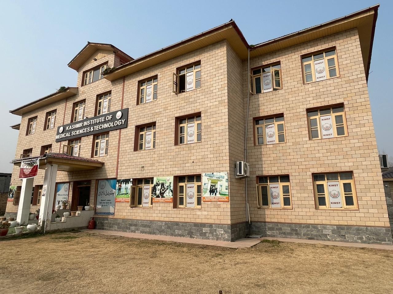 The three-storey Kashmir Institute of Medical Sciences & Technology campus building with the institute's name above the entrance